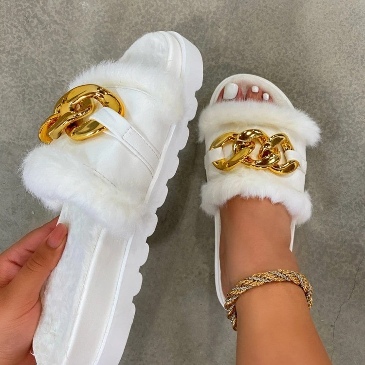 WHITE FLUFFY WINTER SLIPPERS WITH GOLD BUCKLE CHAIN DESIGN.